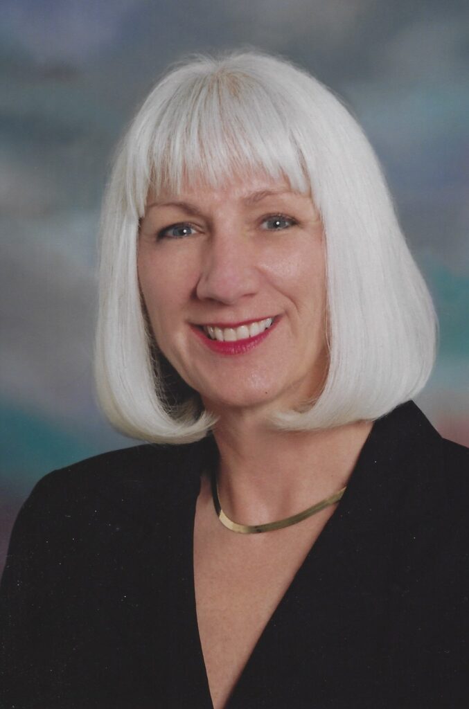 A woman with white hair and wearing black.